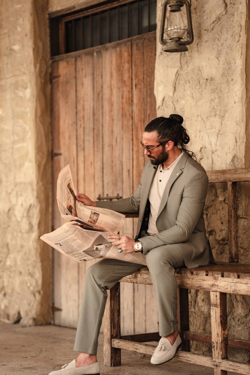 Casual men's suit in pastel green by Mazonni, styled with white sneakers and a laid-back vibe for outdoor gatherings or travel wear