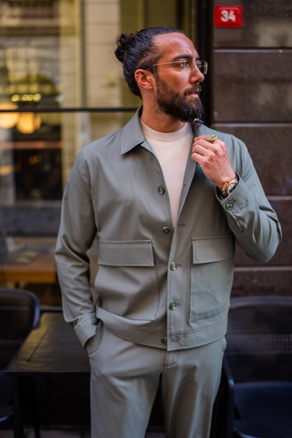 Sage green casual utility suit by Mazonni, styled with buttoned jacket and white tee for a relaxed streetwear vibe
