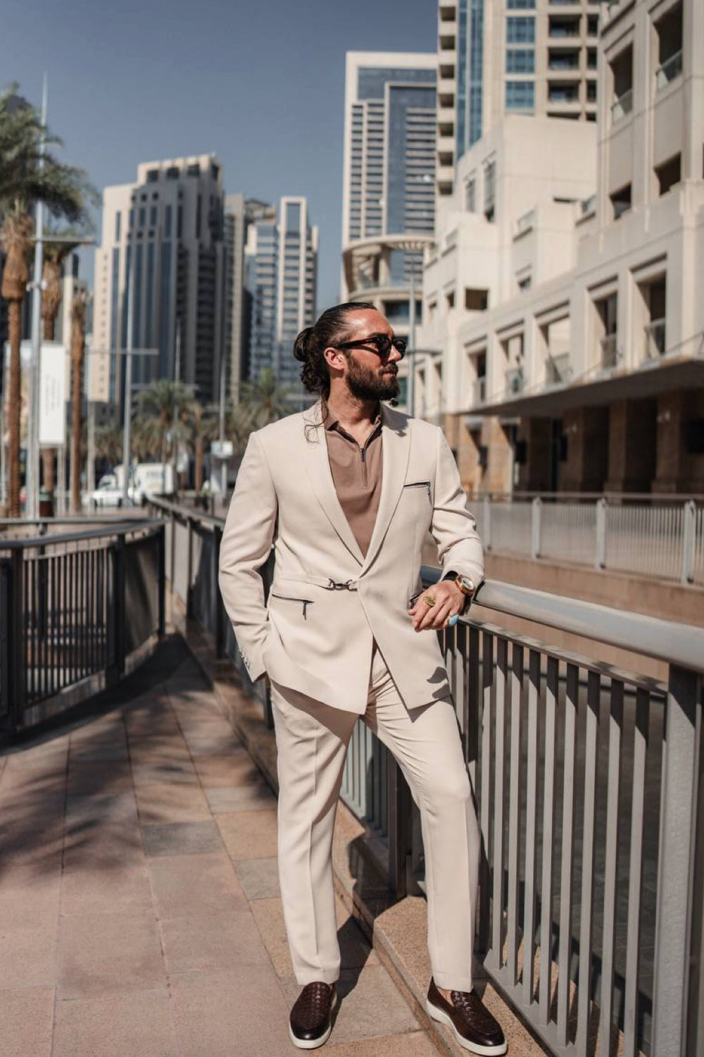 Soft beige Mazonni suit for men contrasted with a brown shirt, captured in a modern cityscape for a polished everyday look