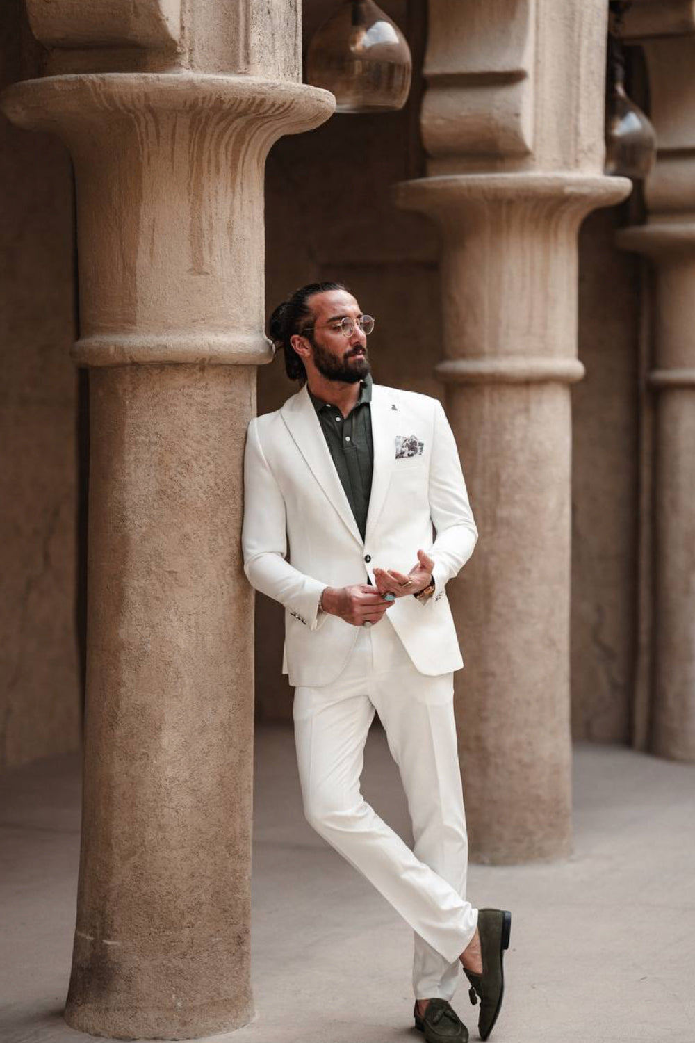 White tailored suit for men by Mazonni featuring clean lines and contrast shirt, great for destination weddings or upscale gatherings