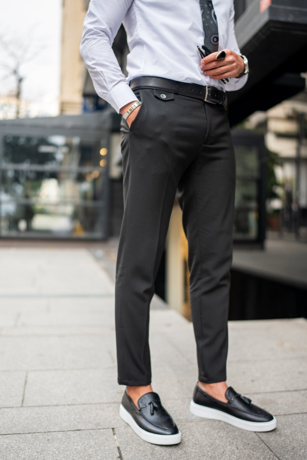 Dark grey dress pants for men by Mazonni styled with white shirt and black loafers