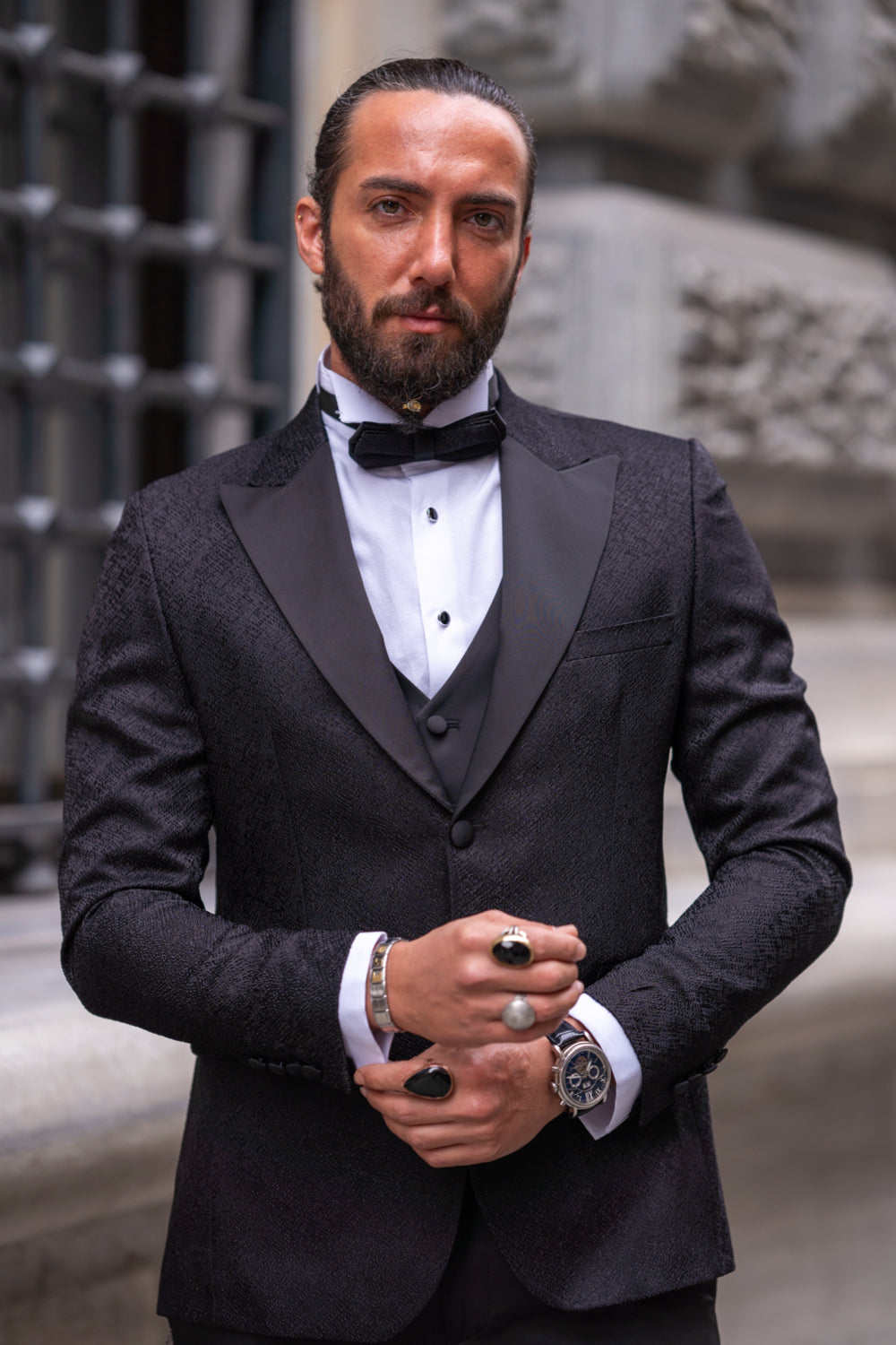 Mazonni men’s black tuxedo with bow tie and contrasting white shirt for refined gala or red carpet occasions