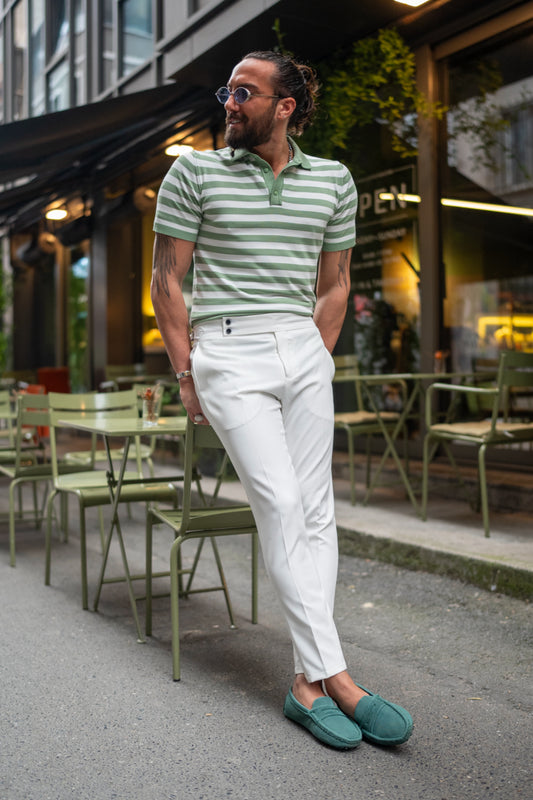 White slim-fit trousers for men by Mazonni styled with striped polo and green loafers