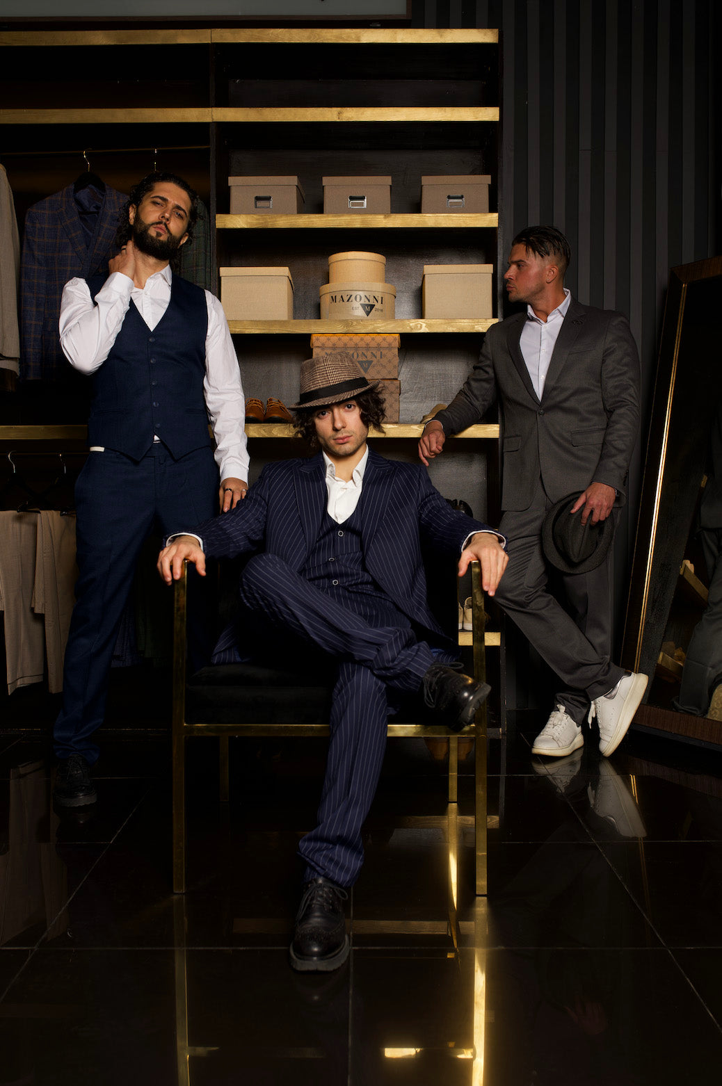 Elegant men's suits by MAZONNI – stylish models showcasing luxury tailored menswear in a modern boutique setting