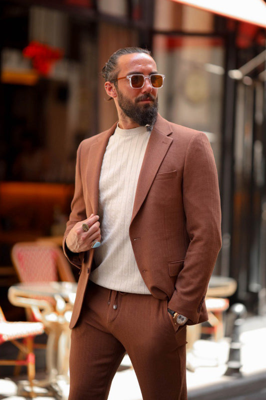 Man wearing a terracotta brown casual suit with drawstring pants and knit top