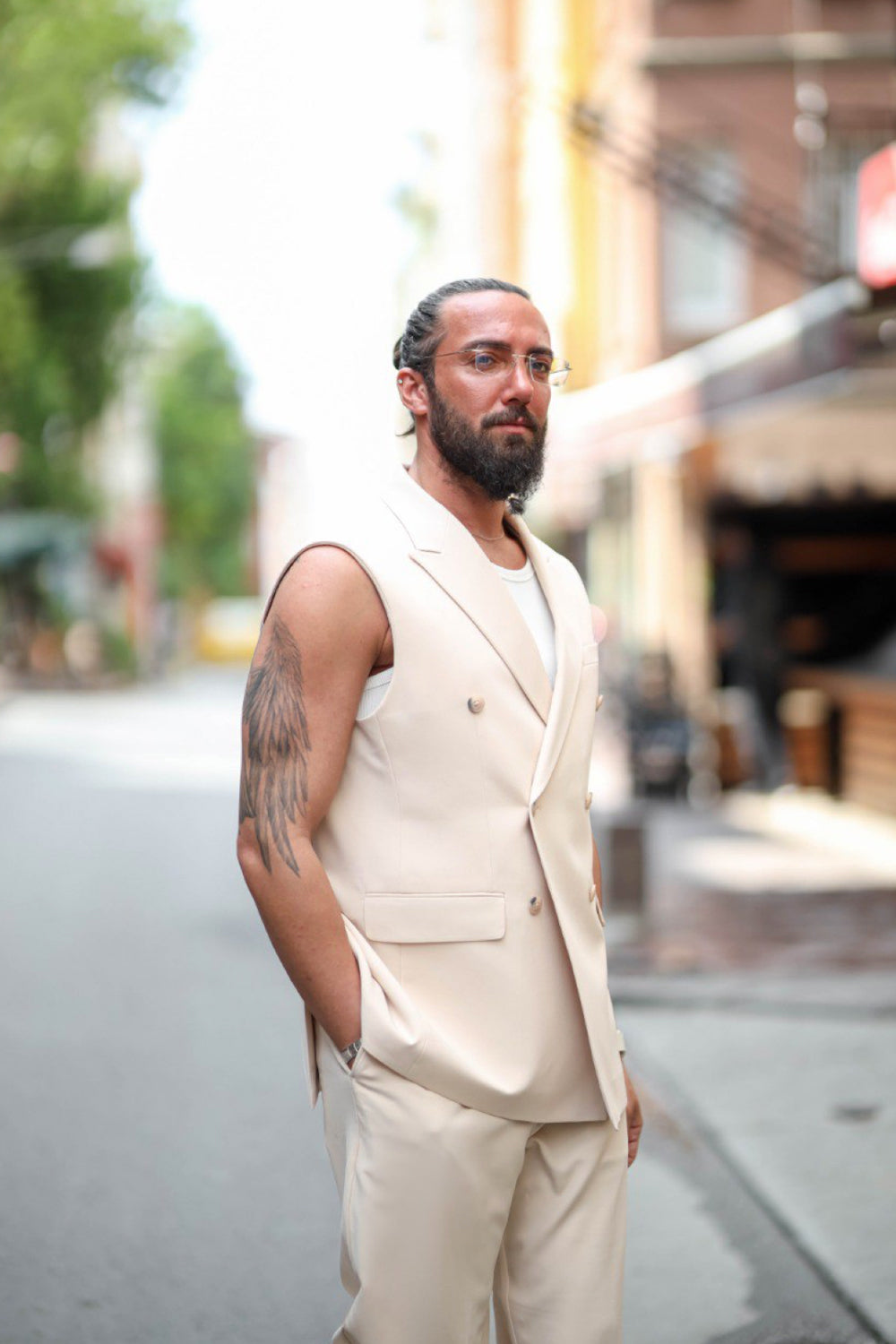 Modern men's beige summer suit with double breasted vest and tapered trousers