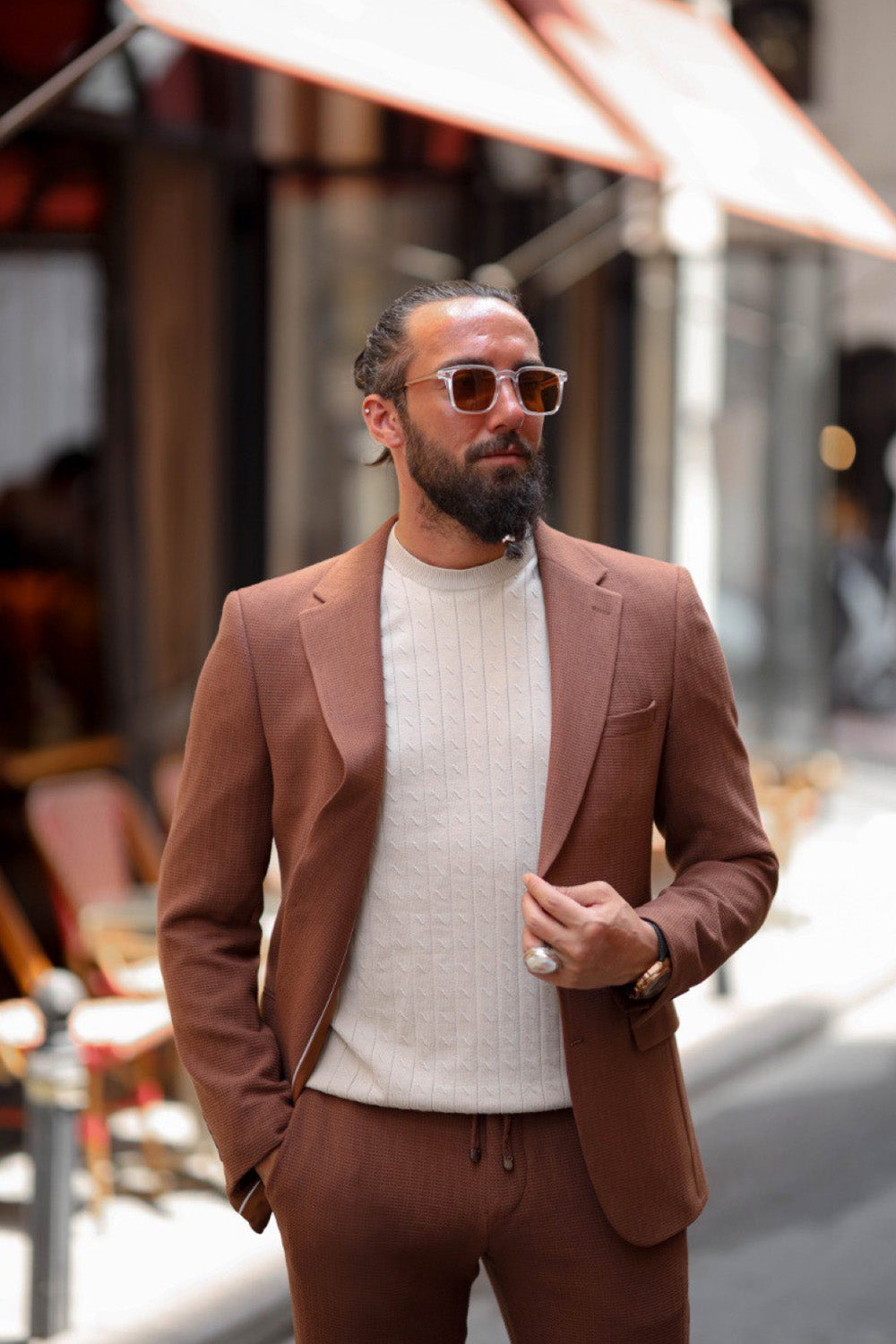 Fashionable man walking in terracotta tailored jacket and pants